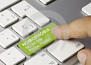 NOMOPHOBIA NO MObile PHone PhoBIA - Inscription on Green Keyboard Key photo