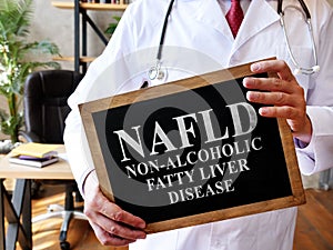 Non-alcoholic fatty liver disease NAFLD the doctor is holding a sign. photo