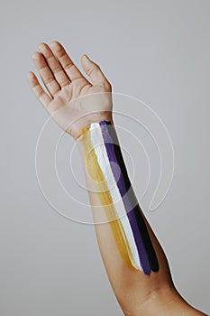 non-binary flag painted in the arm of a person