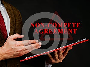 Non compete agreement or clause in red folder. photo