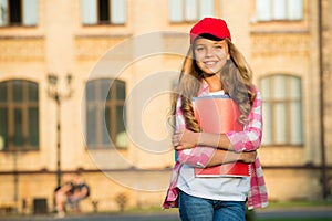 Non-formal education. Happy child hold books in schoolyard. School library. Non-formal learning