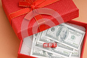 Non fungible token is abbreviated NFT blockchain in a gift box many dollars