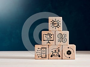Non fungible token NFT transaction icons on a wooden cube pyramid photo