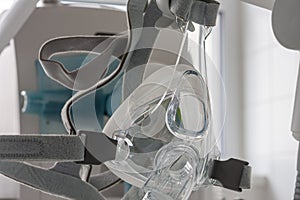 Non-invasive ventilation face mask, on background medical ventilator in ICU in hospital