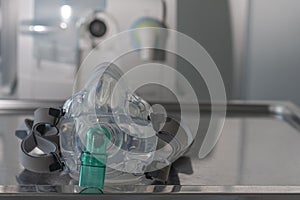 Non-invasive ventilation face mask, on background medical ventilator in ICU n hospital