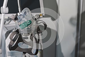 Non-invasive ventilation face mask, on background medical ventilator in ICU n hospital