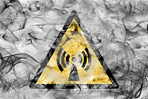 Non ionising electromagnetic radiation hazard warning smoke sign. Triangular warning hazard sign, smoke background.