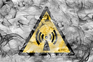 Non ionising electromagnetic radiation hazard warning smoke sign. Triangular warning hazard sign, smoke background. photo