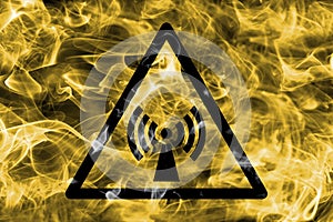 Non ionizing electromagnetic radiation hazard warning smoke sign. Triangular warning hazard sign, smoke background.