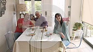 Non-normative family taking a selfie together while having breakfast