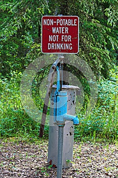 A non-potable water, not for drinking sign near a pump