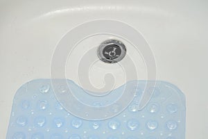 Non-slip blue mat with pimples in the bathroom Anti slip carpet in the bathroom for washing