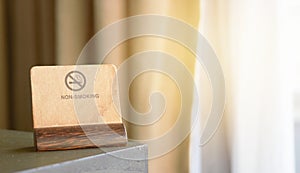 Non-Smoking sign or symbol label card holder on corner of table