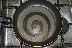 Non-stick frying pan on stainless steel gas stove. Home cooking