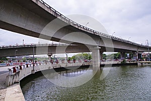 Non-stop speedway Kuril Flyover with cloudy sky and lake in Dhaka