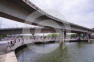 Non-stop speedway Kuril Flyover with cloudy sky and lake in Dhaka