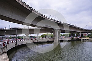 Non-stop speedway Kuril Flyover with cloudy sky and lake in Dhaka Bangladesh