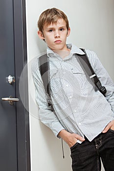 Nonchalant self-assured young schoolboy photo