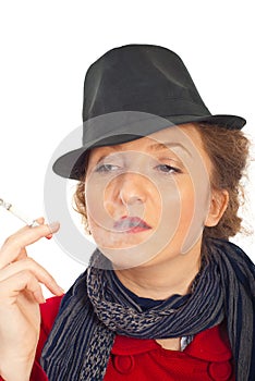 Nonchalant woman with hat smoking