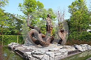 Nong Khai Thailand 12 April 2021 The bronze statue of a serpent and a nakhi in gold. Buddhist beliefs stand outdoors.