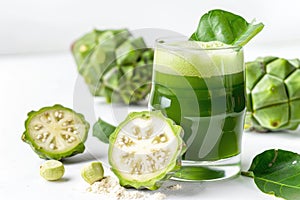 Noni Fruit Juice Isolated, Morinda Citrifolia with Noni Slice and Noni Powder on White Background