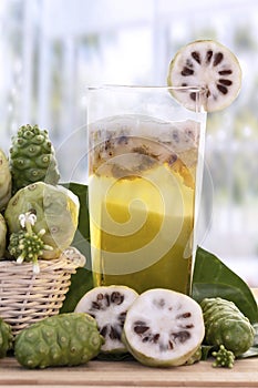 Noni fruit or Morinda Citrifolia with noni juice and leaf in the