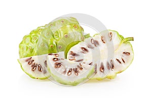 Noni or Morinda Citrifolia fruits with half sliced on white