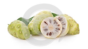 Noni or Morinda Citrifolia fruits with sliced and green leaf isolated on white background