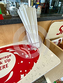 A nonreusable straws at the beverage pickup counter at a Wawa gas station, fast food restaurant, and convenience store