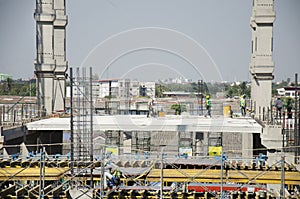 Asian thai workers and heavy machinery working builder new building at construction site high-rise building in Bangkok, Thailand.