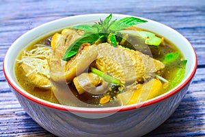 Noodle with chicken in bowl on wood background with clipping path. Tasty noodle.