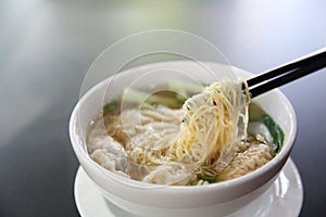 Noodle and wonton soup on a bowl