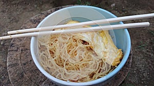 noodle with egg in the bowl with a chopstick