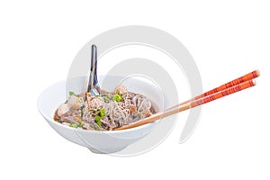 Noodle meat ball and pig piece in bowl on table with broth intense. top view isolated white background and clipping path