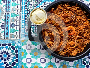 Noodle paella (fideuÃ¡). Typical Catalan dish made with noodles and seafood with garlic sauce and oil