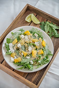 Noodle Salad with mango, feta cheese and arugula