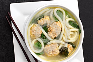 Noodle soup with chicken meatballs and baby spinach