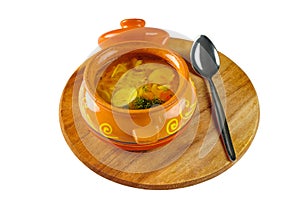 Noodle soup with chicken and quail egg in a pot on round wooden Board