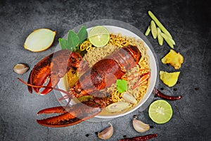 Noodles bowl lobster spicy soup - Cooked seafood with instant noodles soup lobster dinner table and spices ingredients on black