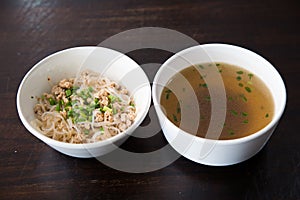 Noodles  in bowl on wooden background, selective focus. Asian meal on a table