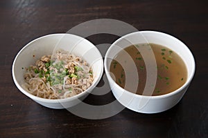 Noodles  in bowl on wooden background, selective focus. Asian meal on a table