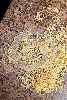 Noodles from the cut dough in the kitchen