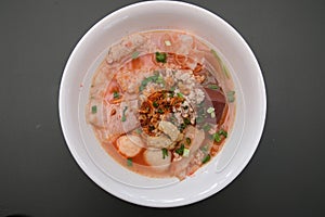 Noodles with meatballs in pink soup or Yen Ta Four Noodles in Asian style