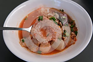 Noodles with meatballs in pink soup or Yen Ta Four Noodles in Asian style