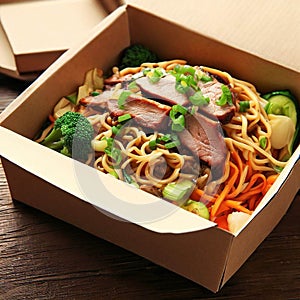 Noodles with pork and vegetables in take-out box on wooden table