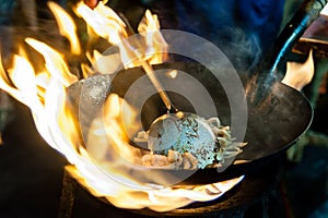 Noodles prepared in a Wok on open fire on Yaowarat Road, Bangkok