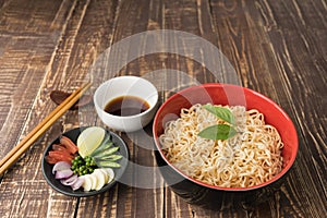 Noodles with sauce or shoyu and ingredient on table wood vintage backgroound in close up.