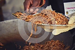 Noodles serving in paper plate at market food stall