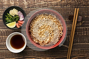 Noodles with shoyu or sauce and ingredient on wood backgroound t