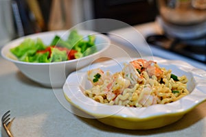 Noodles and shrimp dish on counter top